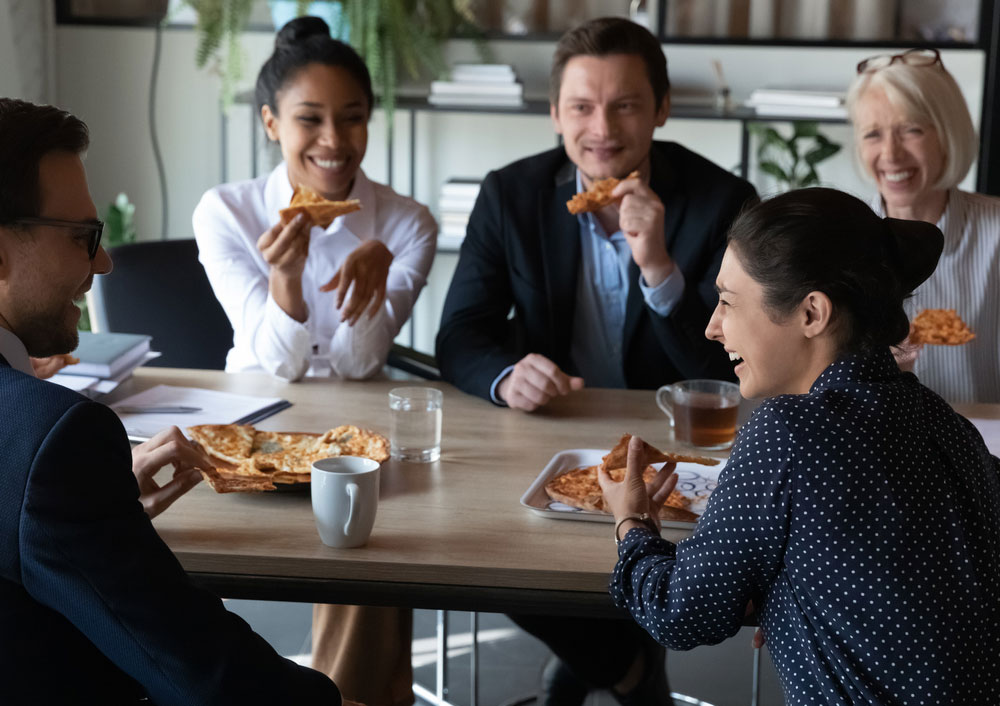 Business employees eating pizza