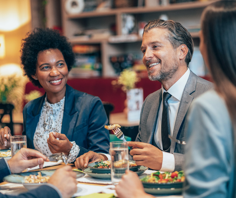 Group of business diners enjoying a meal at a restaurant