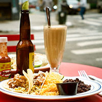 A plate with tacos, beans, and rice.