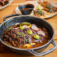 A bowl with fajita and vegetables