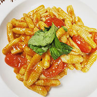 Bowl of pasta with sauce and basil on top
