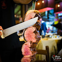 Meat being sliced at a Brazilian Steakhouse