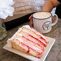 A slice of cake with coffee