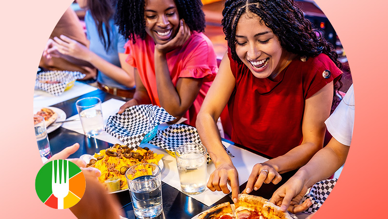 Group of business diners sitting together at a restaurant and sharing food. 